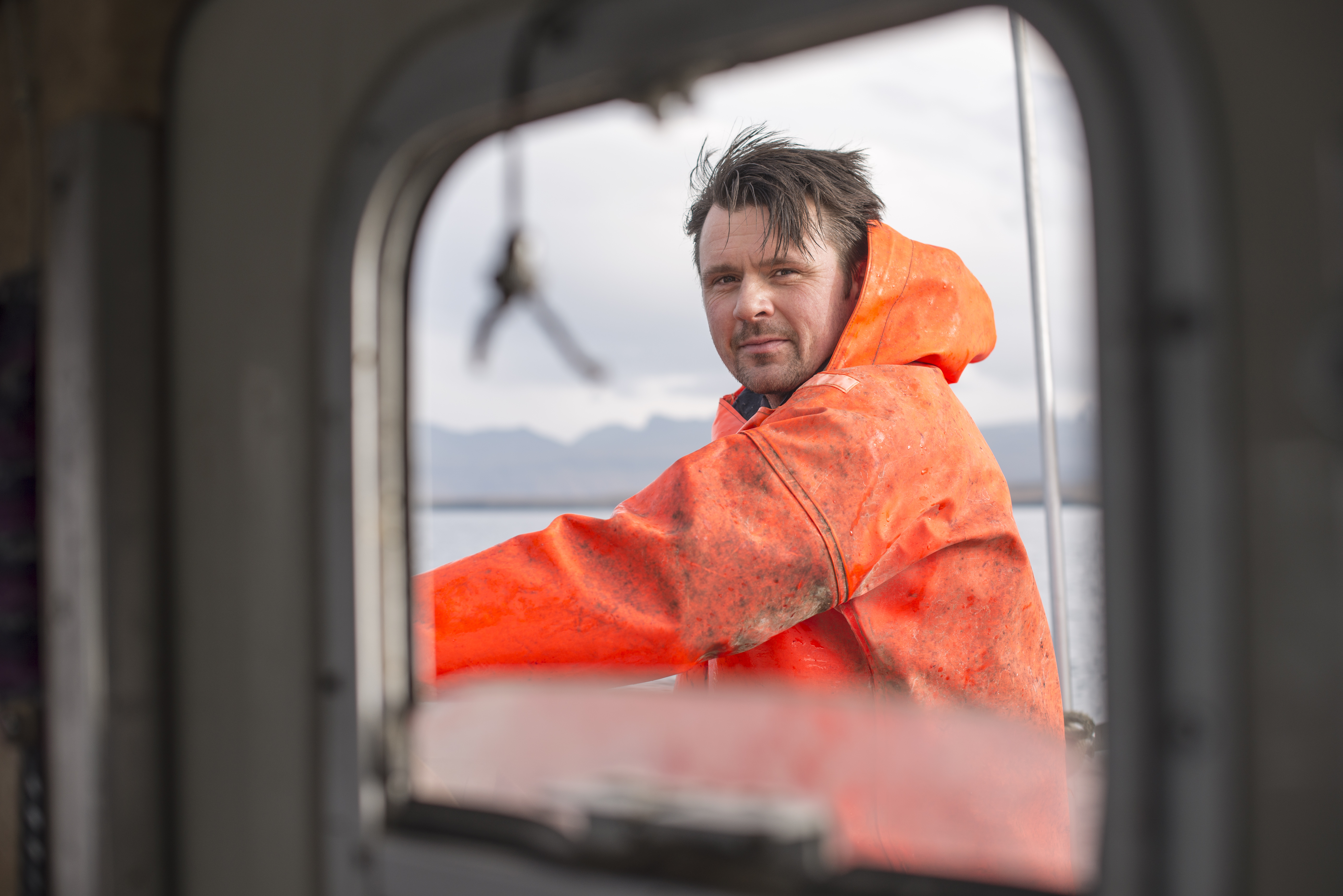 Fisherman Seen Through Fishing Boat Window